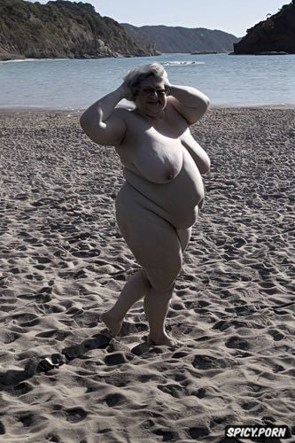 naked fat short woman standing at nudist beach, small boobs