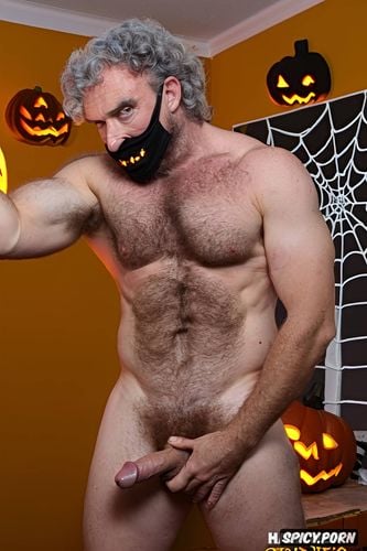 solo hairy gay muscular old man with a big dick showing full body and perfect face beard showing hairy armpits indoors chubby body wearing a halloween mask