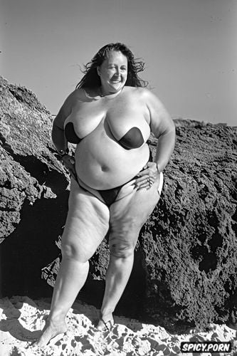 wide hips, very massive natural melons exposed, standing at a beach