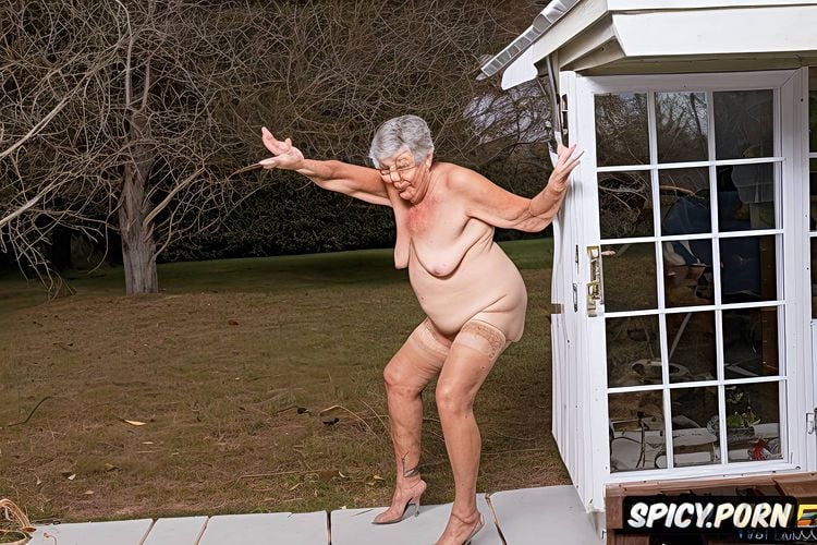 naked old granny in the window of the house scratches her furry pubis