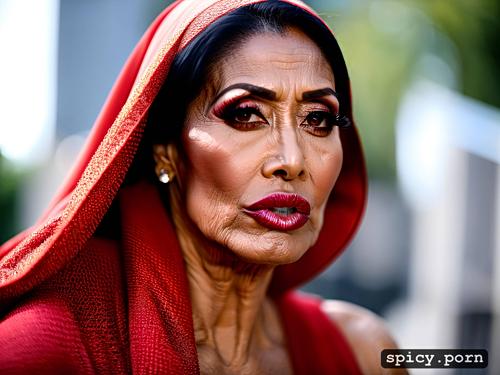 wears a hijab kneels while looking up at camera, 70 year old indonesian woman with big eyes and lips and lashes