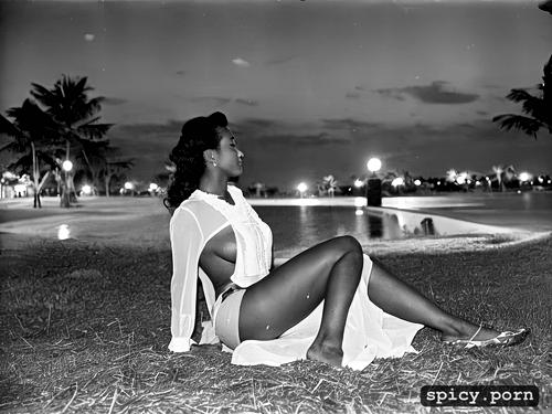 her skin glistens with a light sweat, 1950s island bar resort at night