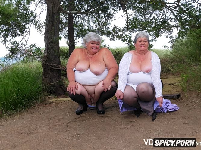 rainy day, a camcorder shot of two olds ssbbw hispanic grannies squatting naked at beach