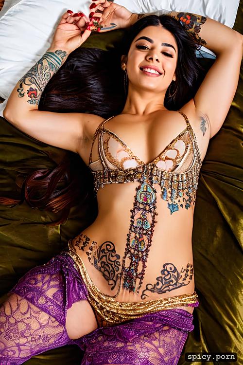 tattoos on armpit, lying on bed, mahendi on hands, arms rise laughing