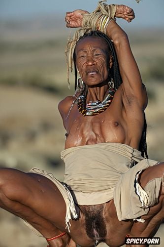big nose, sweaty, homeless ethnic ebony granny, squatting in a desert with legs apart