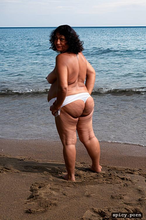 standing, from behind, at beach, sagging fat belly, curly short hair