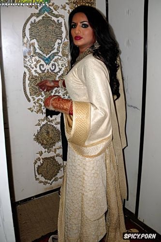 pakistani muslim bride wearing traditional islamic wedding gown standing in the gloryhole room