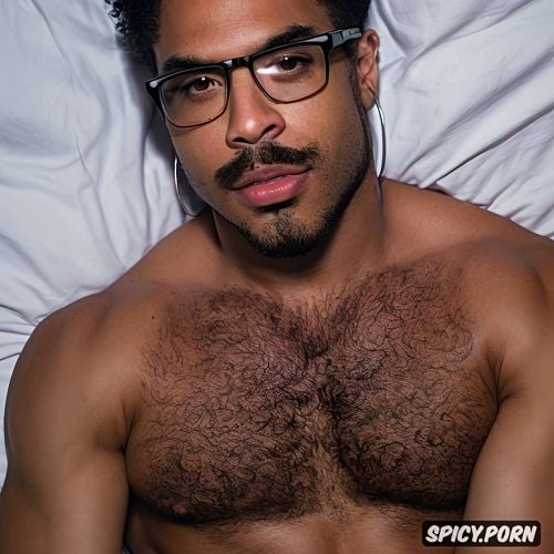 posing naked on bed, light brown skin, black rimmed glasses