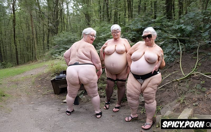 very very old granny, very obese, enormous huge tits, spread legs in an underground garage