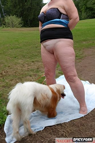 which she has between her legs, plump midget, legs wide apart showing her wet and excited pussy to her dog with his tongue out