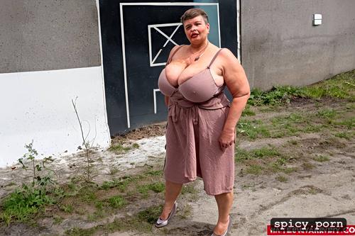 completely huge floppy saggy breasts on obese 60 years old posh russian woman large hairy cunt fat very stupid cute face with small nose much makeup semi short hair standing straight in siberian empty concrete parking lot very large very fat floppy tits full body view large view rich fat lady style