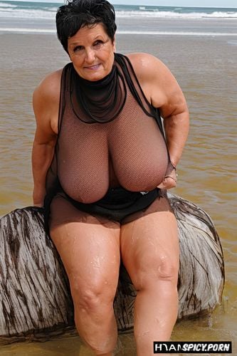 age, hourglas curvy model, wrinkled face, she is sitting on a beach spreading her pussy