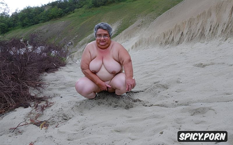 a camcorder shot of two olds ssbbw hispanic grannies squatting naked at beach