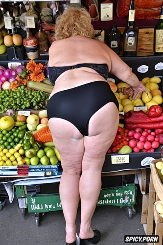 bulging ass, naked fat old woman looking askance at a market stall full of dildos and inflatable dolls